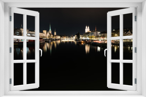 Fototapeta Naklejka Na Ścianę Okno 3D - Zurich, ZH / Switzerland - January 4, 2019: night time city skyline view of Zurich with the river Limmat