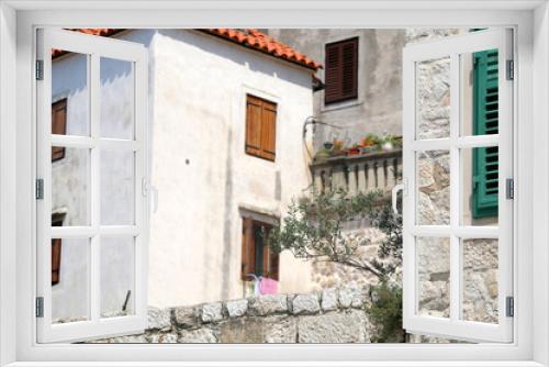Fototapeta Naklejka Na Ścianę Okno 3D - Traditional Mediterranean architecture in Sibenik, Croatia. Stone walls and woode windows with olive plant in the garden. Sibenik is popular summe travel destination.