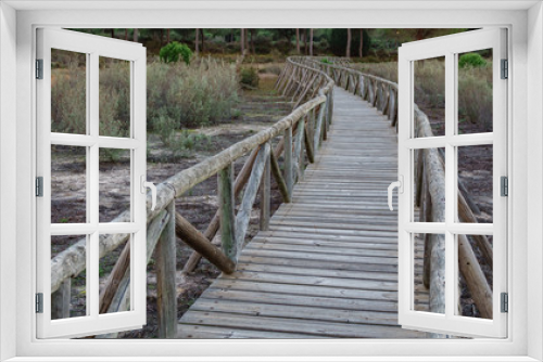 Fototapeta Naklejka Na Ścianę Okno 3D - Wide angle of wooden footbridge track over dry wetlands