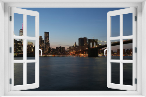 Fototapeta Naklejka Na Ścianę Okno 3D - View from the sea on the evening of New York and the bridge