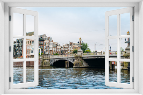 Fototapeta Naklejka Na Ścianę Okno 3D - Amsterdam, Netherlands September 5, 2017: Bridge and Amstel river.