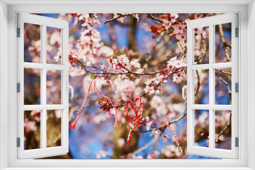 Fototapeta Naklejka Na Ścianę Okno 3D - Branch of blossoming cherry tree with red and white martisor
