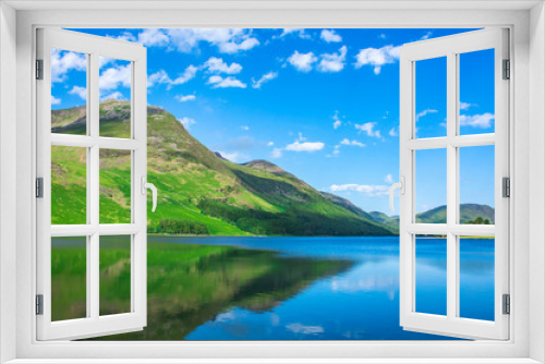 Fototapeta Naklejka Na Ścianę Okno 3D - Beauty of british countryside in spring.Green mountain reflecting in crystal clean lake surface and blue sky with few clouds above horizon.