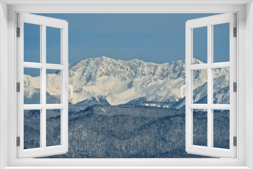 Fototapeta Naklejka Na Ścianę Okno 3D - Panorama of snowy mountains. Winter forest and rocky peaks in the snow. Sunny winter day.
