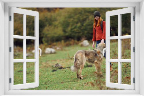 Fototapeta Naklejka Na Ścianę Okno 3D - woman traveler with a dog in nature