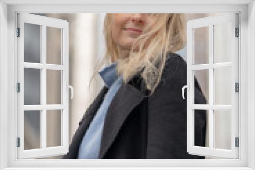 Happy and cheerful businesswoman with blonde hair in the city of London