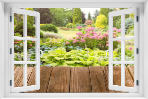 Fototapeta Naklejka Na Ścianę Okno 3D - Wooden table and blurred view of beautiful garden on background. Space for text