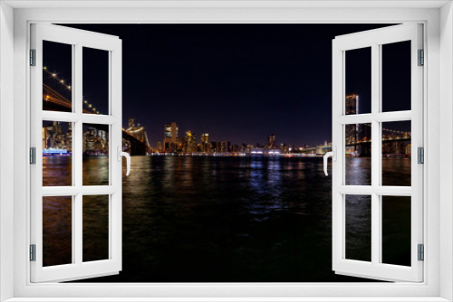Fototapeta Naklejka Na Ścianę Okno 3D - New York at night. Stitched panorama of a lower Manhattan from Empire Fulton Ferry park with Brooklyn and Manhattan bridges.