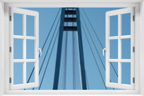Fototapeta Naklejka Na Ścianę Okno 3D - Cables and tower of the suspension bridge with blue skies in the background
