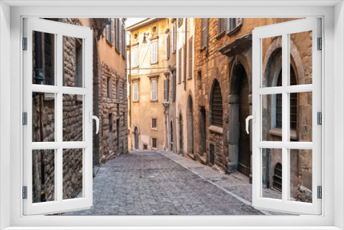 Fototapeta Naklejka Na Ścianę Okno 3D - Beatiful Old Medieval European narrow empty street of a medieval town on the morning taken in Bergamo, Citta Alta, Italy