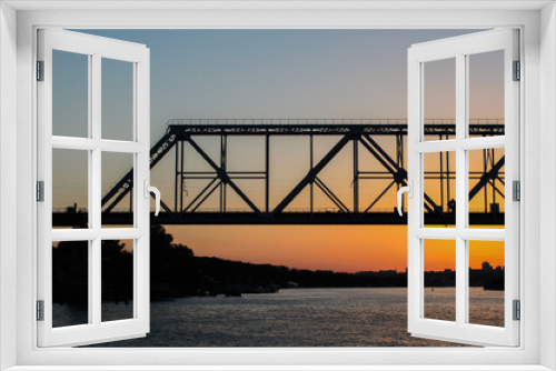Fototapeta Naklejka Na Ścianę Okno 3D - Rails bridge on a sunset in the river