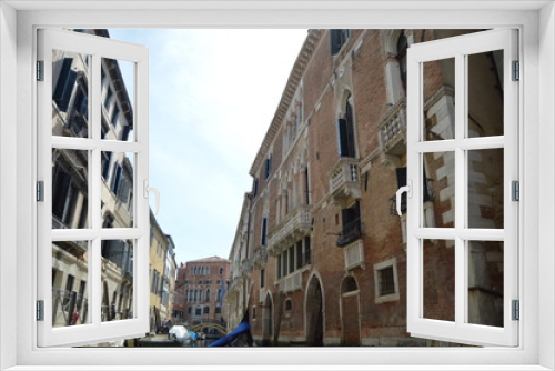 Fototapeta Naklejka Na Ścianę Okno 3D - Beautiful Venetian Style Palaces Seen Walking On Gondola In Venice. Travel, holidays, architecture. March 29, 2015. Venice, Veneto region, Italy.