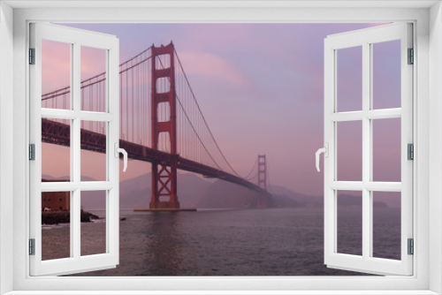 Fototapeta Naklejka Na Ścianę Okno 3D - Beautiful view of Golden Gate Bridge during a cloudy sunset. Taken in San Francisco, California, United States.