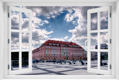 Fototapeta Naklejka Na Ścianę Okno 3D - Wroclaw, Poland, town square. This picture shows town square of Wroclaw, Poland. There is an old tenement house in the middle. Dark and light clouds makes a view with full of contrast.