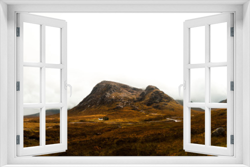 Fototapeta Naklejka Na Ścianę Okno 3D - Panorama of white litte Scottish cottage near Glen Coe on the way to the Isle of Skye with fog covered mountain range (Glen Coe, Scotland, Europe)