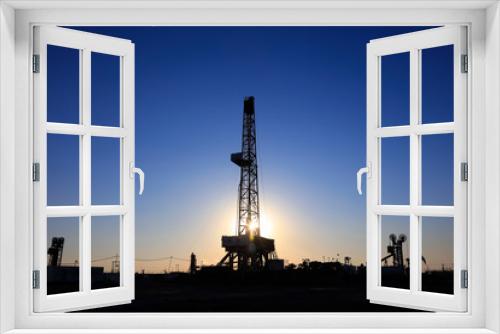 Fototapeta Naklejka Na Ścianę Okno 3D - Oil drilling derrick in oilfield