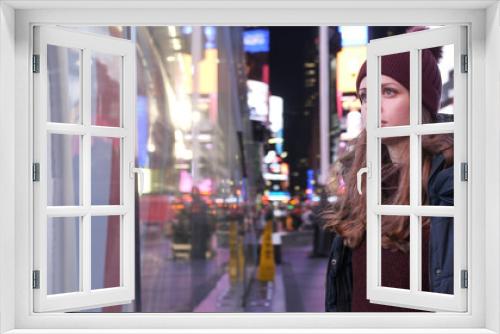 Walking on Times Square New York by night while doing a sightseeing trip to Manhattan