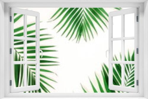 Fototapeta Naklejka Na Ścianę Okno 3D - tropical green palm branches pattern frame on a white background. top view.copy space.abstract.