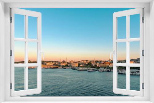 Fototapeta Naklejka Na Ścianę Okno 3D - Scenic view of coastline of Istanbul and Eminonu pier at sunset