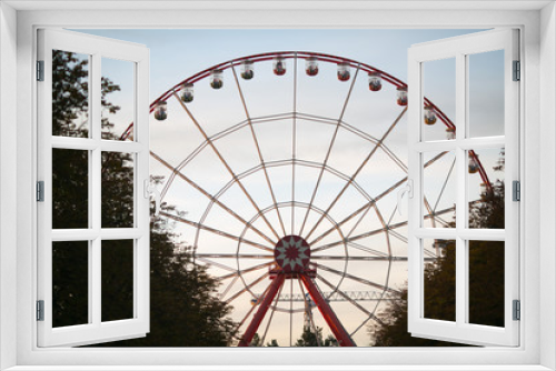 Fototapeta Naklejka Na Ścianę Okno 3D - attraction Ferris wheel against a background of evening dark blue sky with clouds
