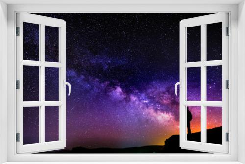 Fototapeta Naklejka Na Ścianę Okno 3D - Beautiful starry night, man silhouette with a camera looking at the Milky Way galaxy.