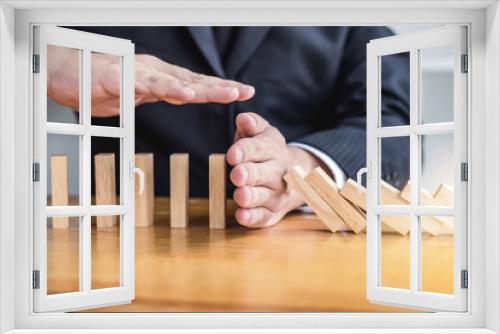 Fototapeta Naklejka Na Ścianę Okno 3D - Wooden game strategy, Businessman hand stopping falling wooden dominoes effect from continuous toppled or risk and protection, strategy and successful intervention concept for business