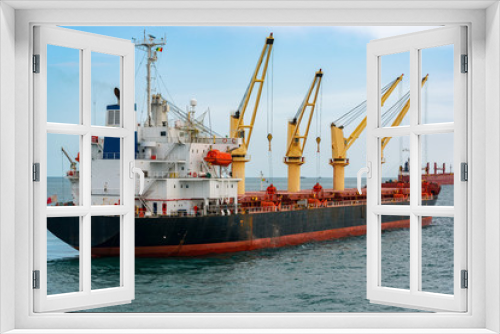 Fototapeta Naklejka Na Ścianę Okno 3D - Big ore carrier vessel is awaiting loading of bauxite ore at outer anchorage of Kamsar port, Guinea, West Africa.
