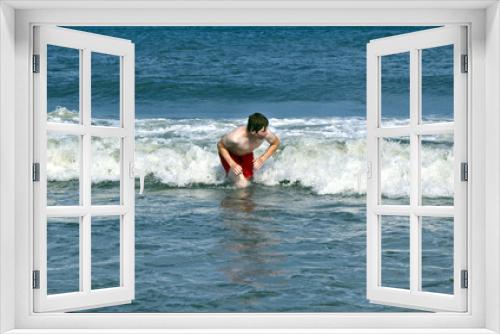 Fototapeta Naklejka Na Ścianę Okno 3D - young boy is body surfing in the waves