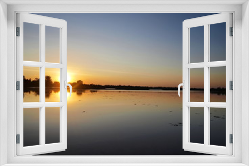 Fototapeta Naklejka Na Ścianę Okno 3D - Beautiful sunset over the reservoir and Silhouettes landscape view sunset Water reflection On the background is a black cloud and blue sky.
