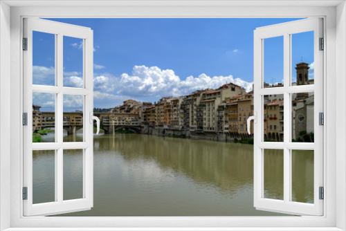 Fototapeta Naklejka Na Ścianę Okno 3D - The Ponte Vecchio is a medieval stone closed-spandrel segmental arch bridge over the Arno River, in Florence, Italy, noted for still having shops built along it, as was once common.