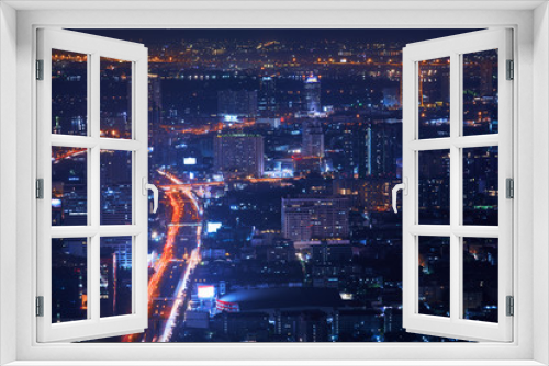 Fototapeta Naklejka Na Ścianę Okno 3D - night top view cityscape from highest rooftop building view with light tail traffic