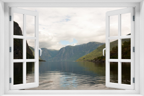 Fototapeta Naklejka Na Ścianę Okno 3D - a lake or sea between norwegian fjords and green mountains in a cloudy summer day
