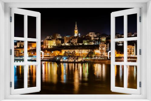 Belgrade, Serbia - February 10, 2019: Panorama of Belgrade with a view from Branko bridge at night with a reflection. View of Cathedral Church of St. Michael the Archangel (serbian: Saborna crkva).