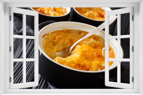 Fototapeta Naklejka Na Ścianę Okno 3D - Homemade potato casserole with sour cream, onions and cheddar cheese close-up in a pan. horizontal