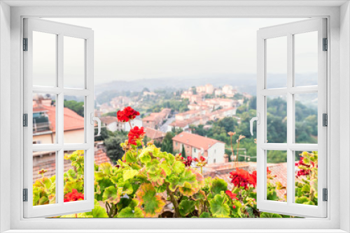 Fototapeta Naklejka Na Ścianę Okno 3D - Chiusi Scalo houses buildings in Umbria, Italy or Tuscany with town cityscape and focus on red geranium flowers in garden foreground