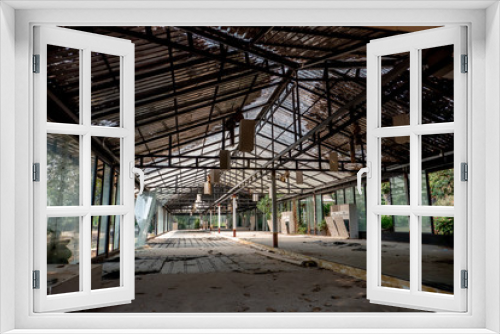 Fototapeta Naklejka Na Ścianę Okno 3D - The abandoned and frightened building with broken door windows ceiling and roof in the day light. 