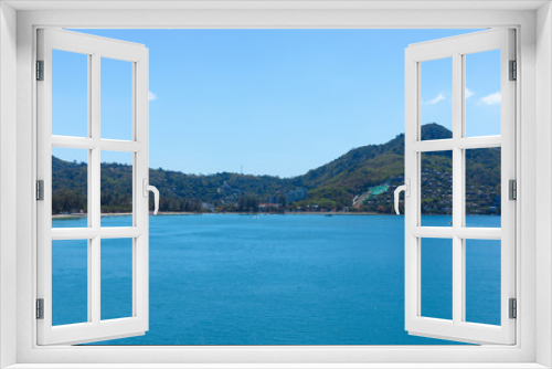 Fototapeta Naklejka Na Ścianę Okno 3D - Blue sky and ocean in cleary day, have Phuket island that can see a lot of hotel near beach on mountain and small boat drive pass through