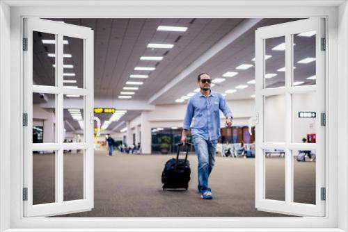 Asian man traveler with suitcases walking and transportation at an airport