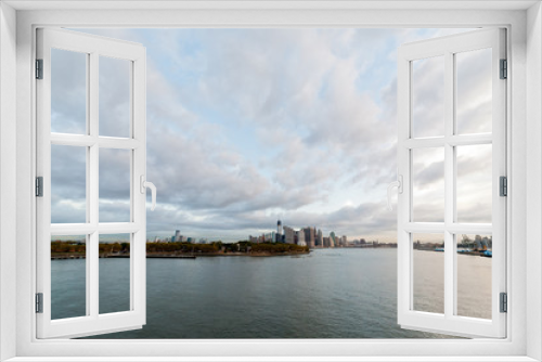 Fototapeta Naklejka Na Ścianę Okno 3D - View of dramatic clouds over New York city skyline and upper Hudson River in morning from Brooklyn Cruise Terminal 