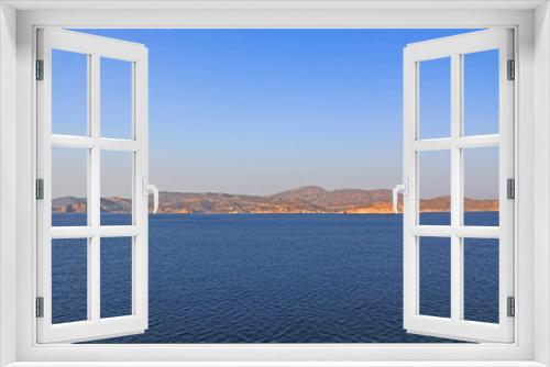 Fototapeta Naklejka Na Ścianę Okno 3D - View of the island of Patmos, Greece in the Aegean Sea where St. Paul wrote the book of Revelation in the Bible with beautiful blue sky and water copy space.