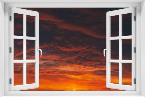 Fototapeta Naklejka Na Ścianę Okno 3D - Fiery red blood vampire dawn. Amazing warm dramatic fire cloudy sky. Vivid orange sunlight. Atmospheric background of sunrise in overcast weather. Hard cloudiness. Storm clouds warning. Copy space.