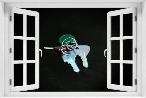 Fototapeta Naklejka Na Ścianę Okno 3D - A bunch of keys on a dark background