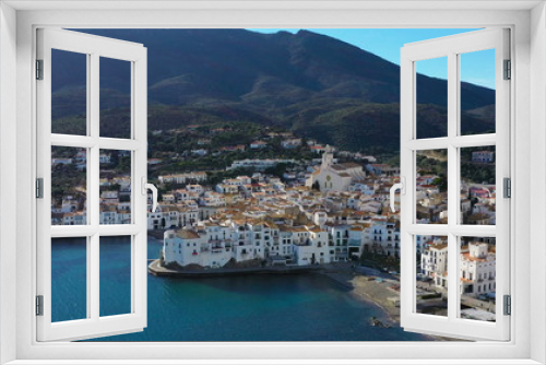 Fototapeta Naklejka Na Ścianę Okno 3D - Adoarble Cadaques Spain. cozy beautiful houses streets and tiled roofs. Aerial drone video footage of the camera approaches the city. sunny daylight. Mountains and the city