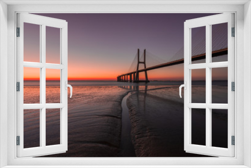 Fototapeta Naklejka Na Ścianę Okno 3D - Peaceful atmosphere at Vasco de Gama Bridge in Lisbon during sunrise. Ponte Vasco de Gama, Lisboa, Portugal