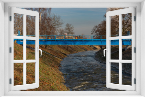 Fototapeta Naklejka Na Ścianę Okno 3D - Blue pipes over Bilina river in Bilina town in winter morning