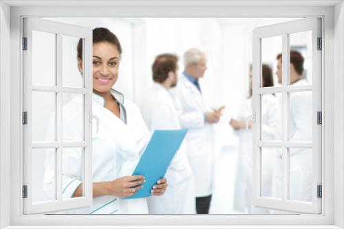 Diverse team of medical professionals standing at the hospital corridor