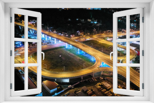 Fototapeta Naklejka Na Ścianę Okno 3D - Aerial View Above of Busy Highway Road Junctions at Night. The Intersecting Freeway Road Overpass. Sochi, Russia