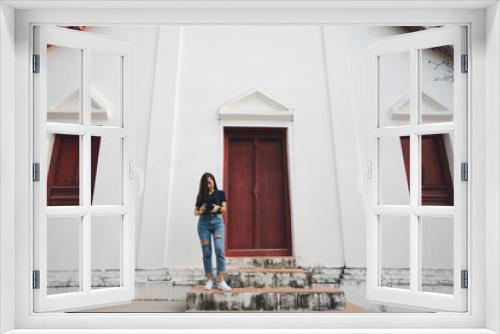 tourist woman a photographer stand in temple in traveler in vacation in Thailand nan province