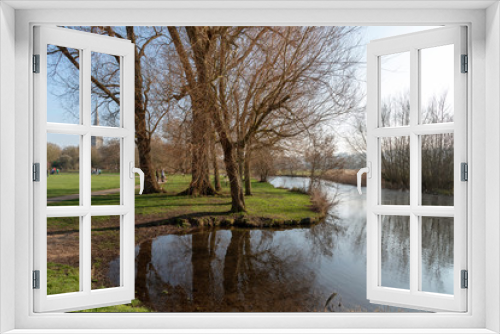 Fototapeta Naklejka Na Ścianę Okno 3D - Salisbury, Wiltshire, England, UK, February 2019. The Bishops Grounds and River Avon overlooked by Salisbury Cathedral during winter.