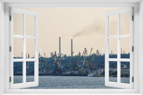 Fototapeta Naklejka Na Ścianę Okno 3D - View of the port, cranes and oil refinery pipes which pollute the atmosphere